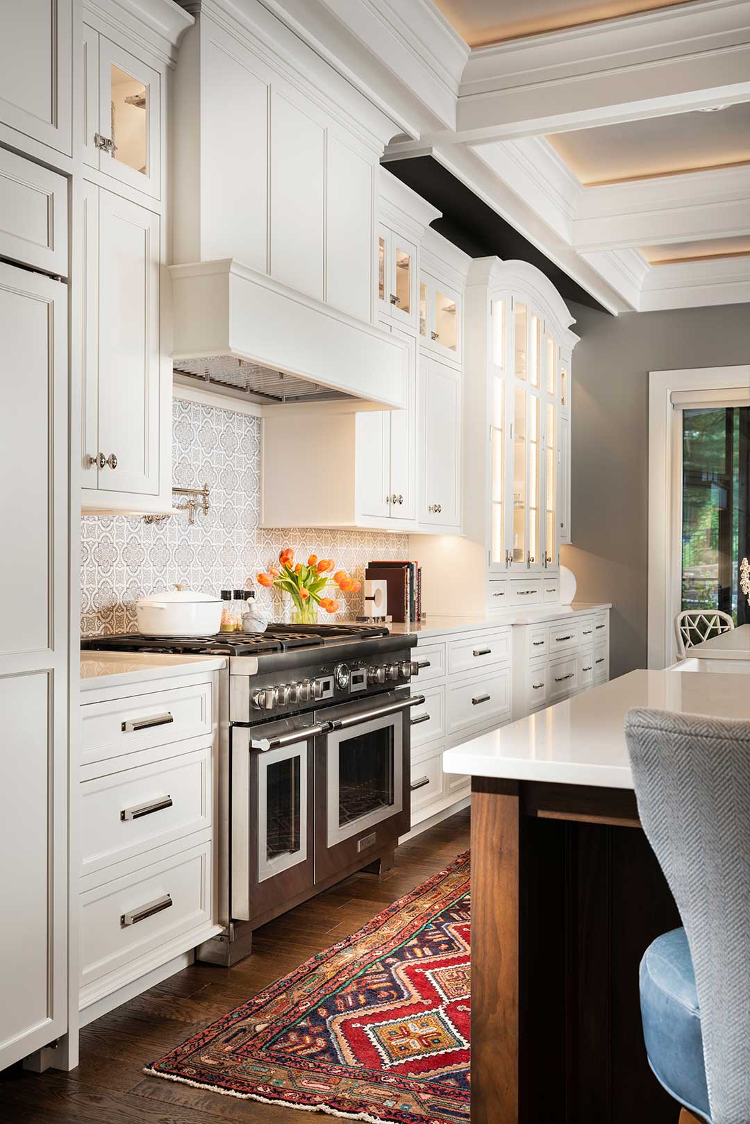 Kitchen design with custom cabinetry with stove hood