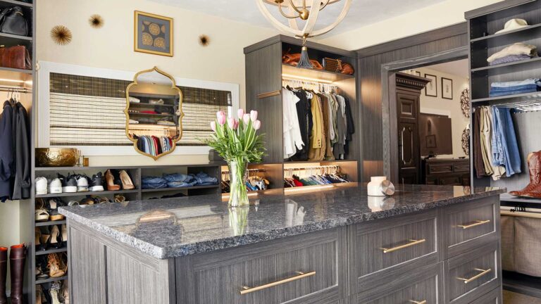Custom closet featuring dresser with granite top
