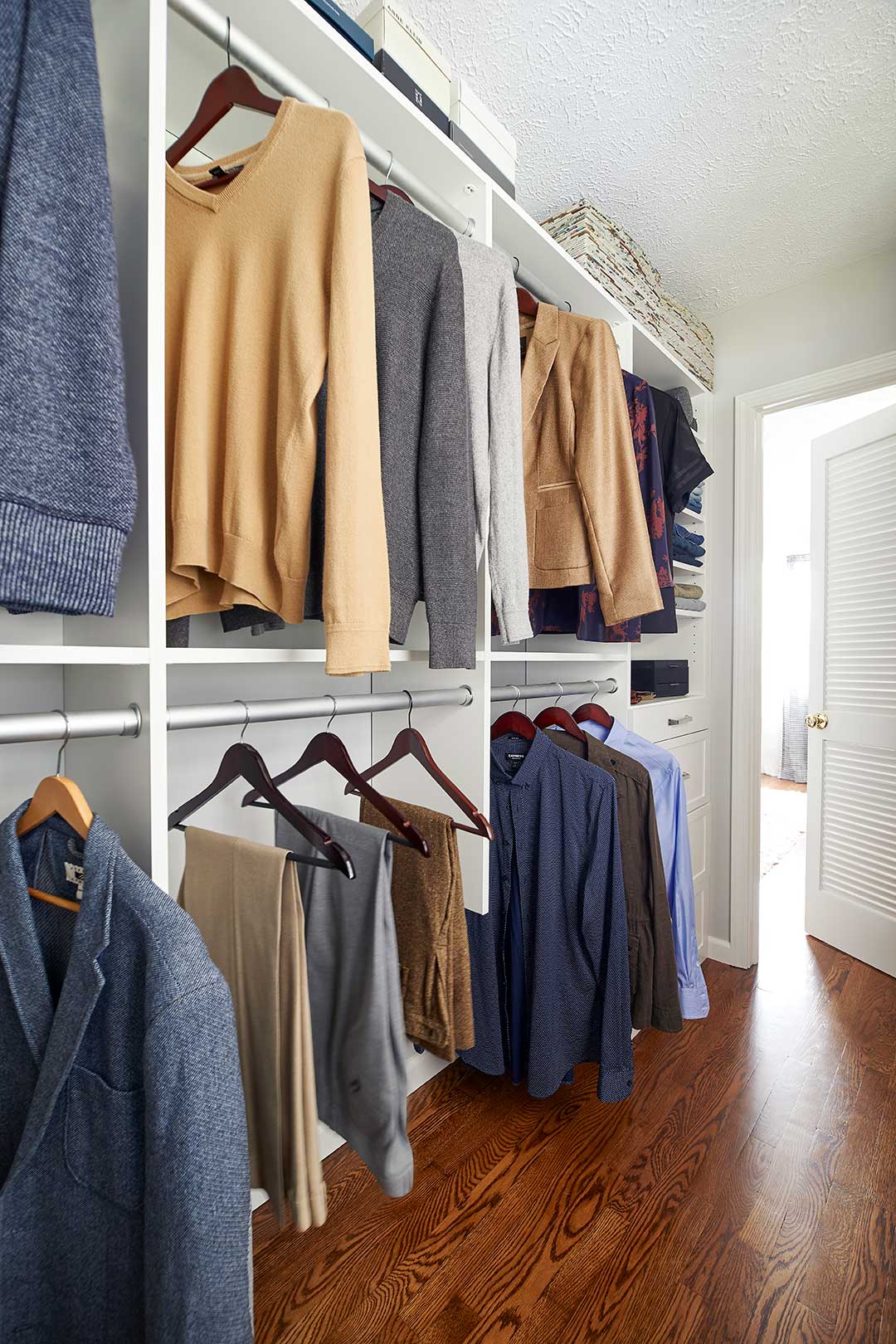 Custom closet build-in showing clothes on racks