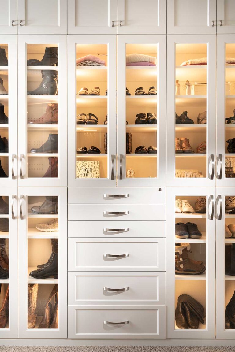 Custom closet built-in showing lighted shoe racks in cabinet