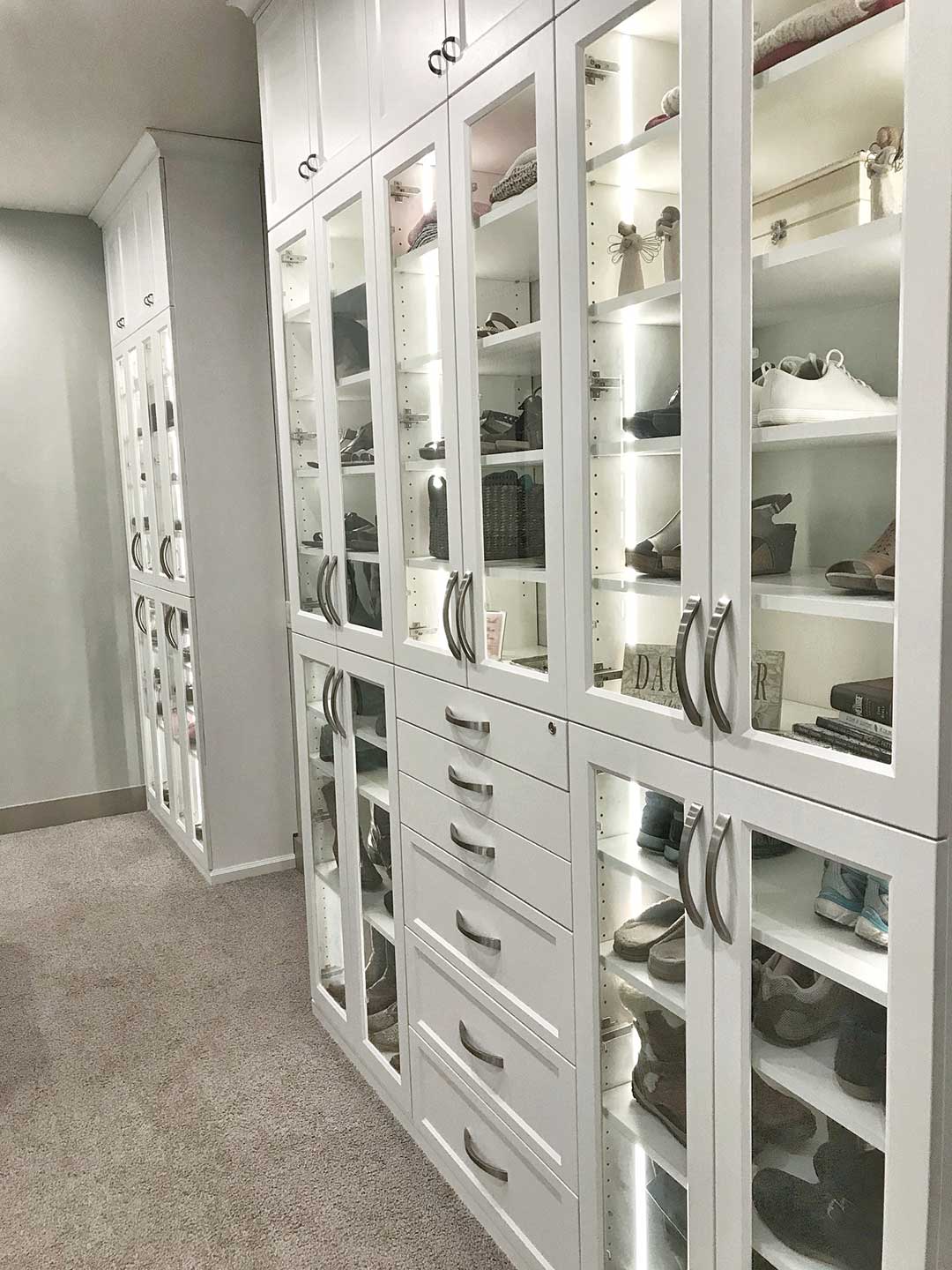 White custom closet with glass doors