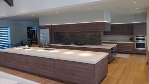 Modern kitchen with clean lines featuring cabinetry and bar