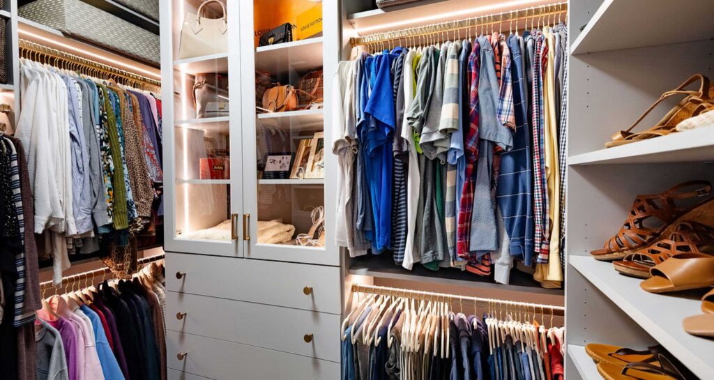 Smaller walk-in closet with organized beauty with lighted hanging systems