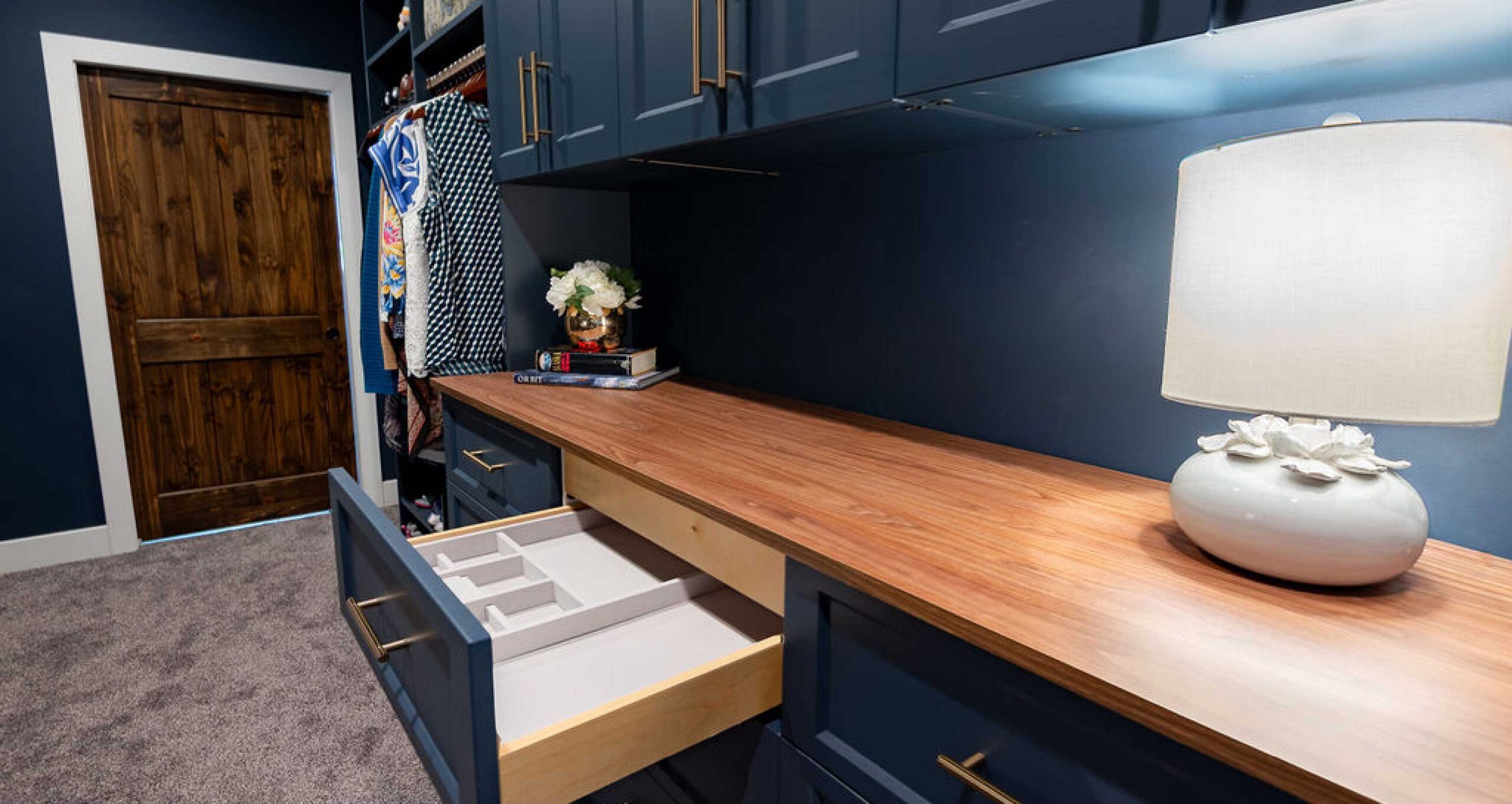 Slate blue closet cabinetry with jewelry drawers