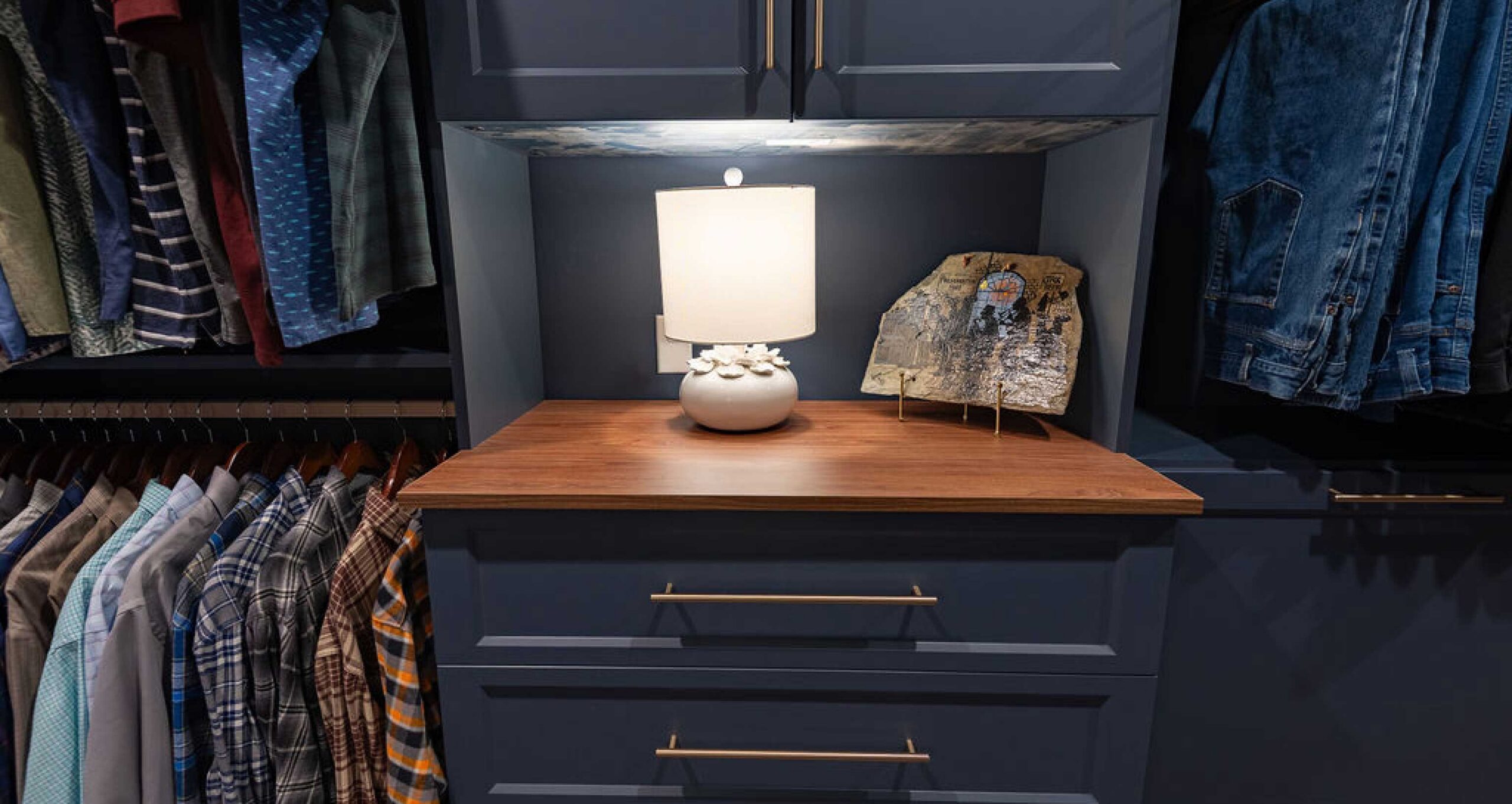 Slate blue closet with natural wood tops