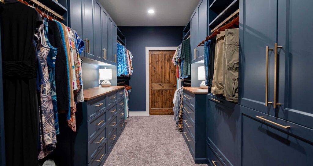 Luxury meets organization in this rich wood closet cabinetry