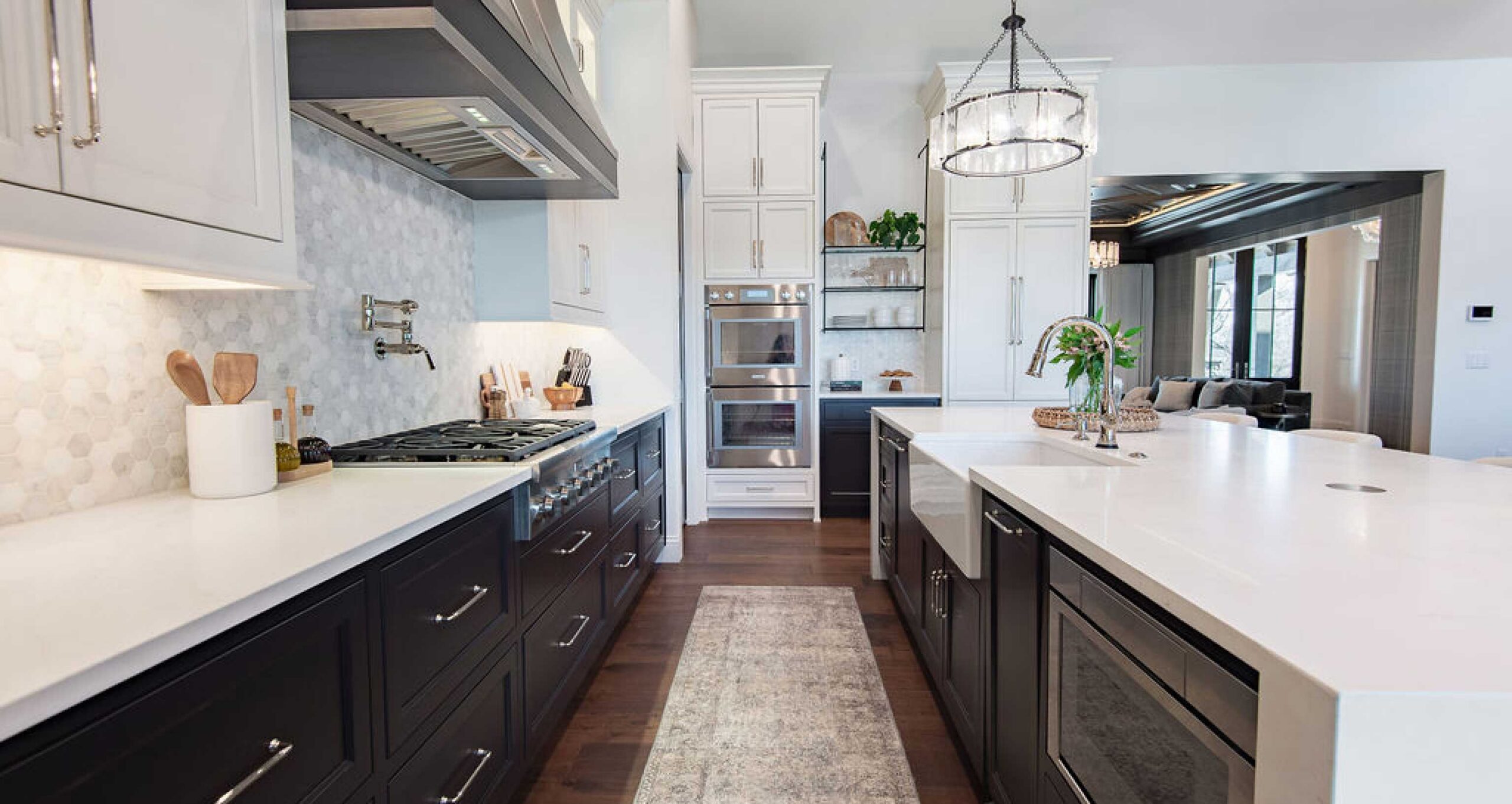 Elegant and open kitchen with white cabinetry featuring walk through area