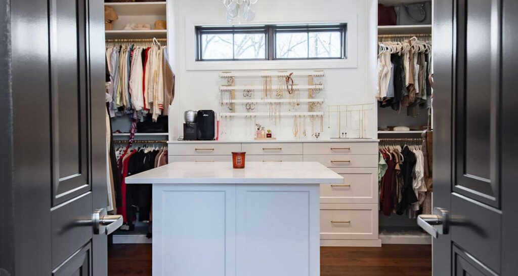 New formal closet featuring modern cabinetry and jewelry station