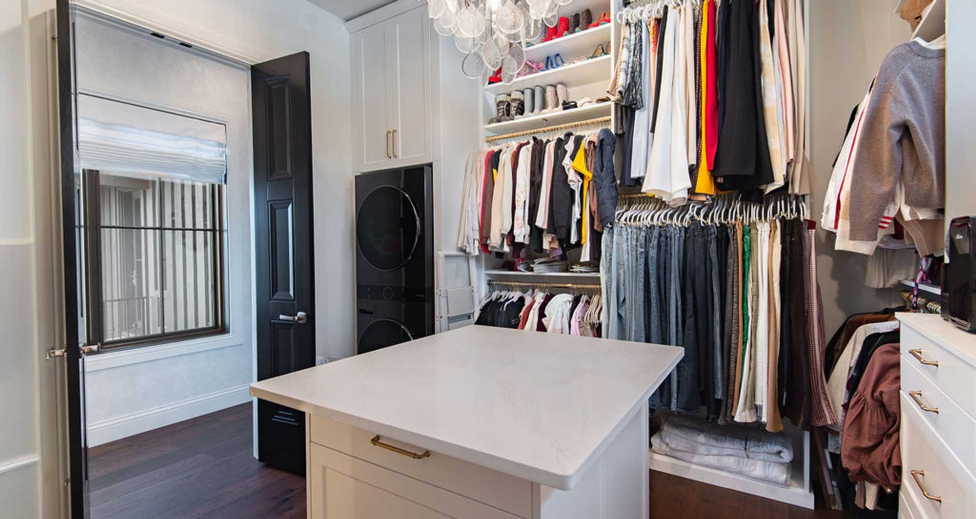 New formal closet featuring hanging systems and washer dryer built-ins