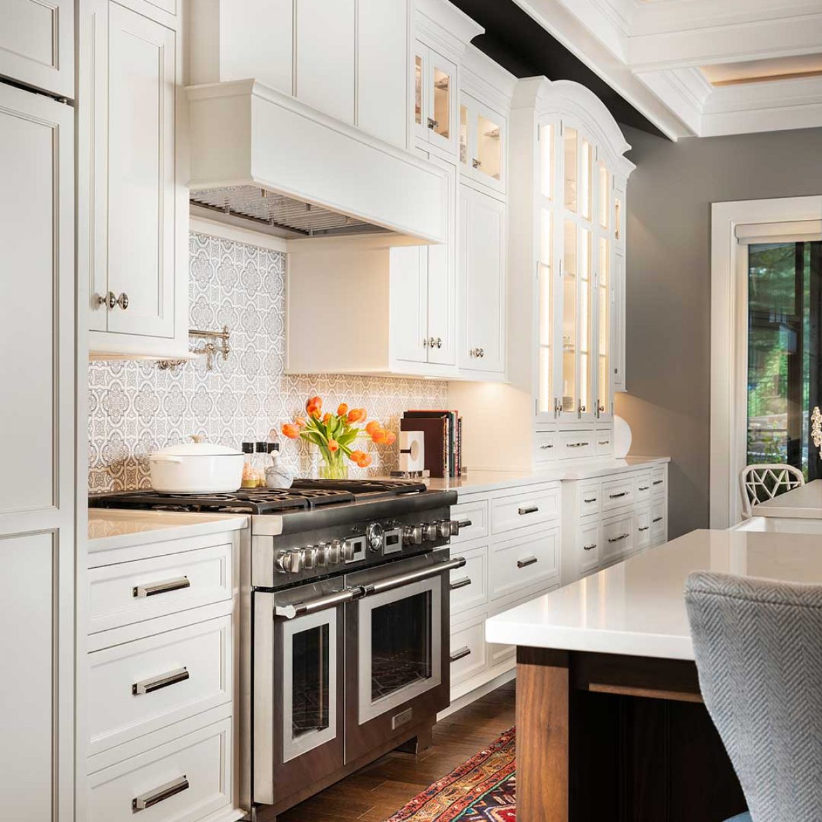 Kitchen design with custom cabinetry with stove hood